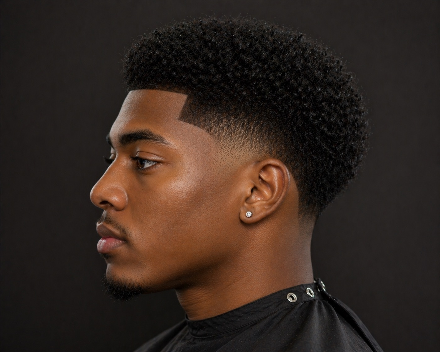 Temple Fade With Rounded Coil Top And Tapered Nape — side profile barber reference photo showing the fade line and top shape