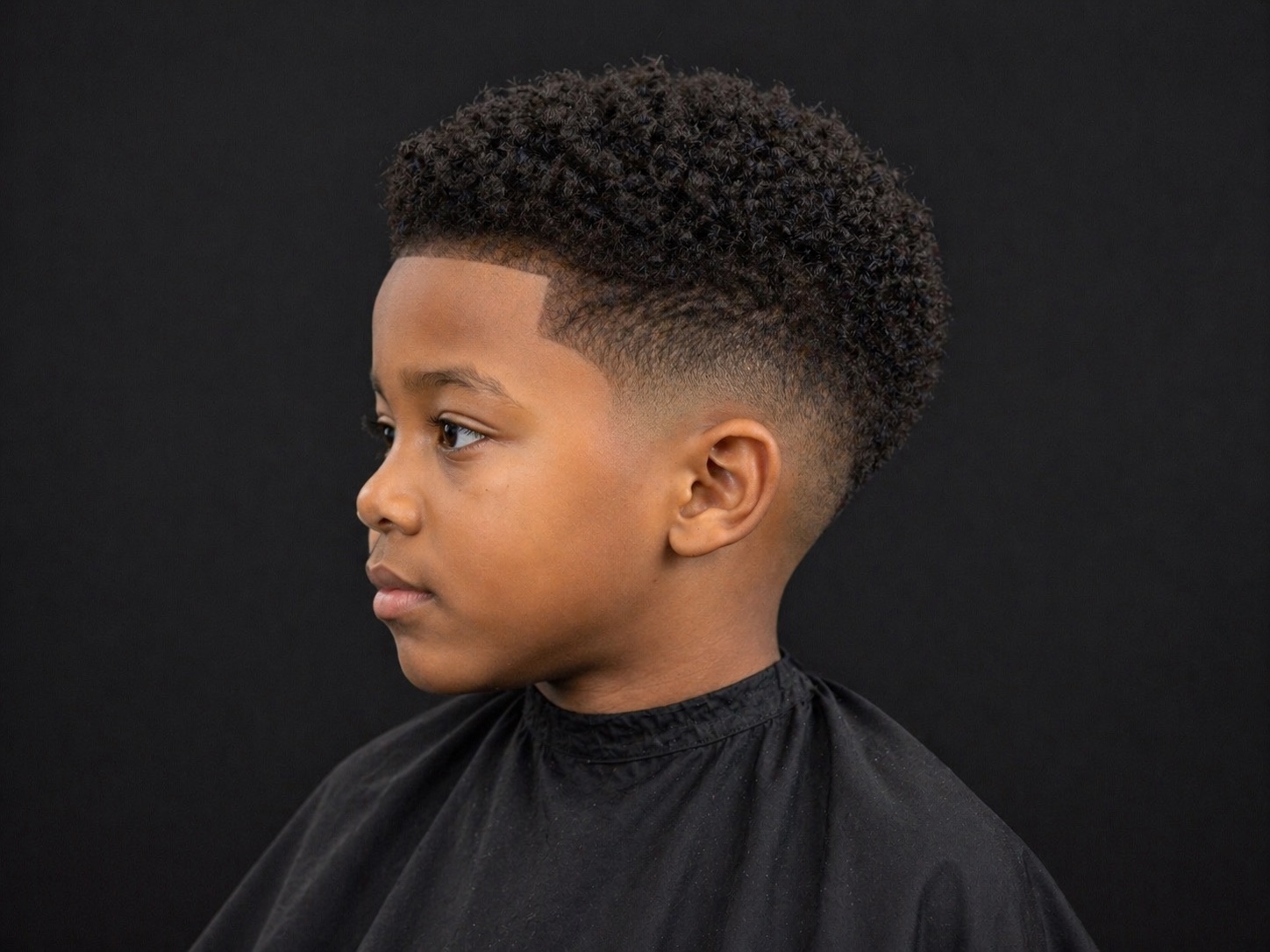 Kids Rounded Afro Taper — side profile barber reference photo showing the fade line and top shape