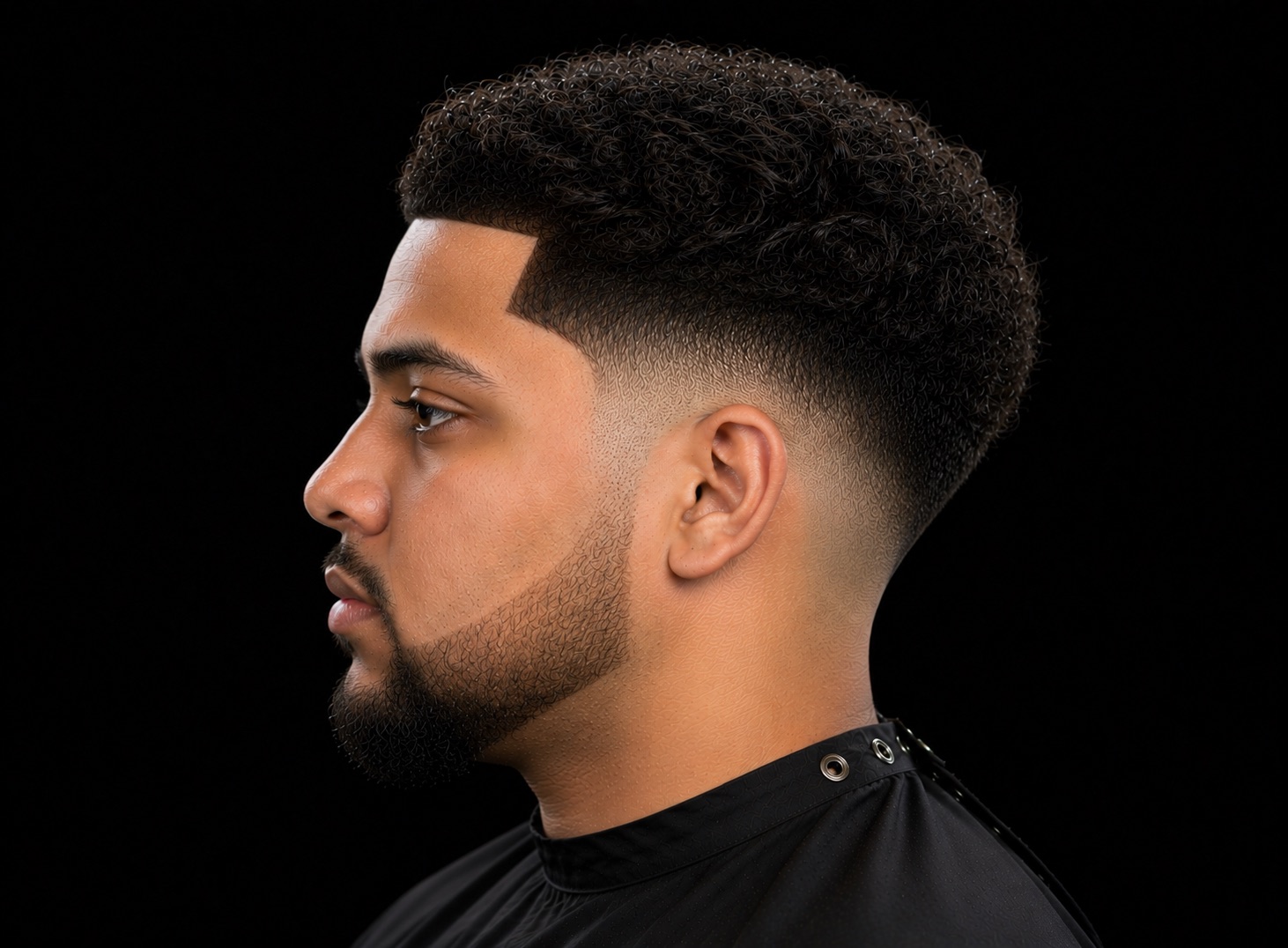 Low Drop Fade With Sponge-Coiled Top — side profile barber reference photo showing the fade line and top shape