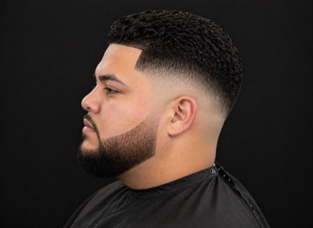 High Skin Fade with Defined Curl Sponge Top — barber reference photo